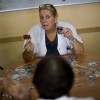 Social worker Cecilia Aceves shows cutouts during a memory activity at the Cuidem La Memoria elderly home, which specializes in Alzheimer patients.
